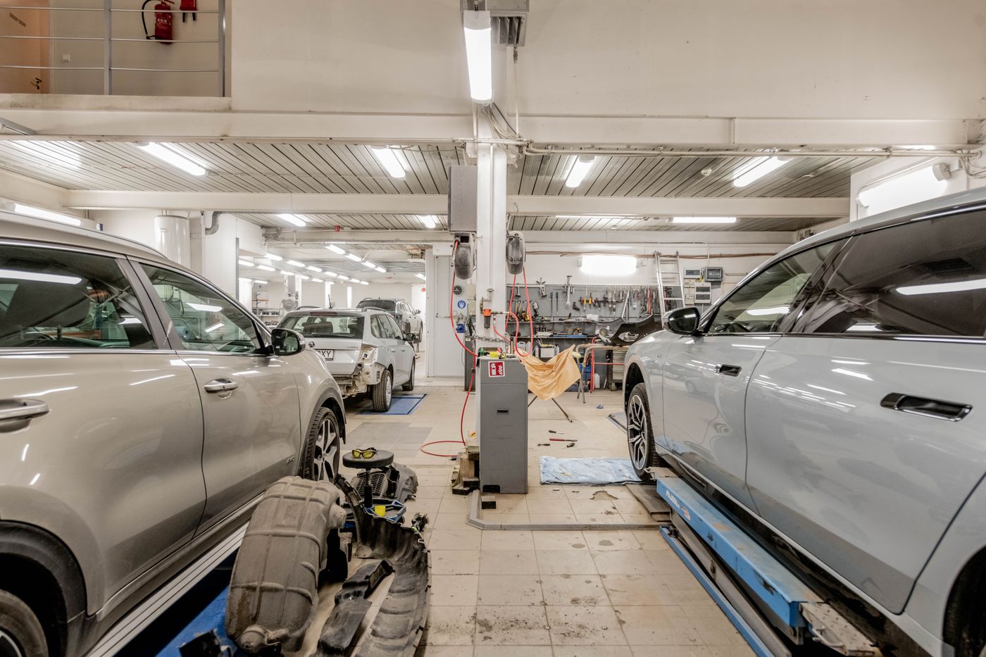 Bright service floor at Grip Tire with cars in the bays