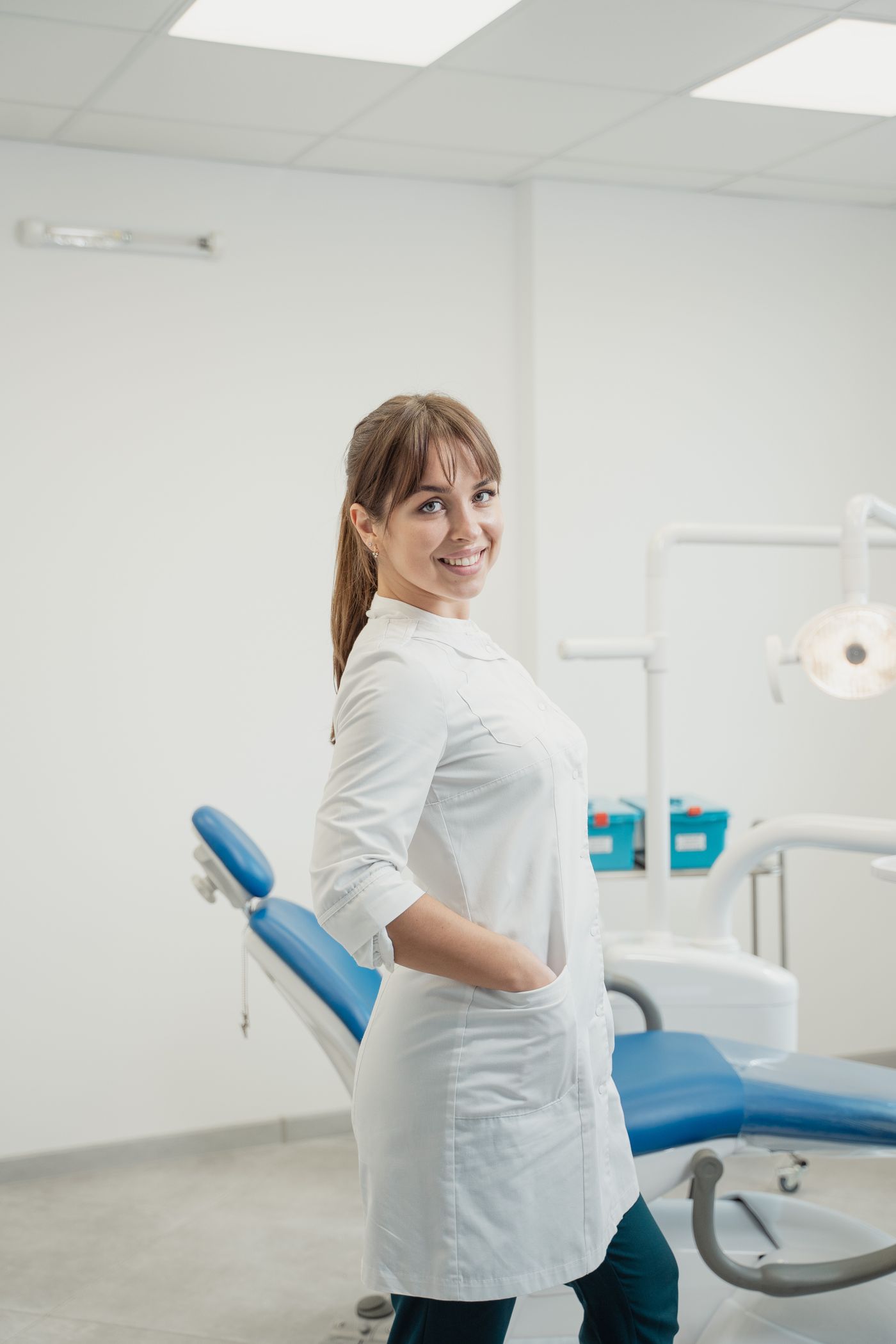 Dr. Elena Marín, founder of Marigold Dental Studio, smiling in the clinic