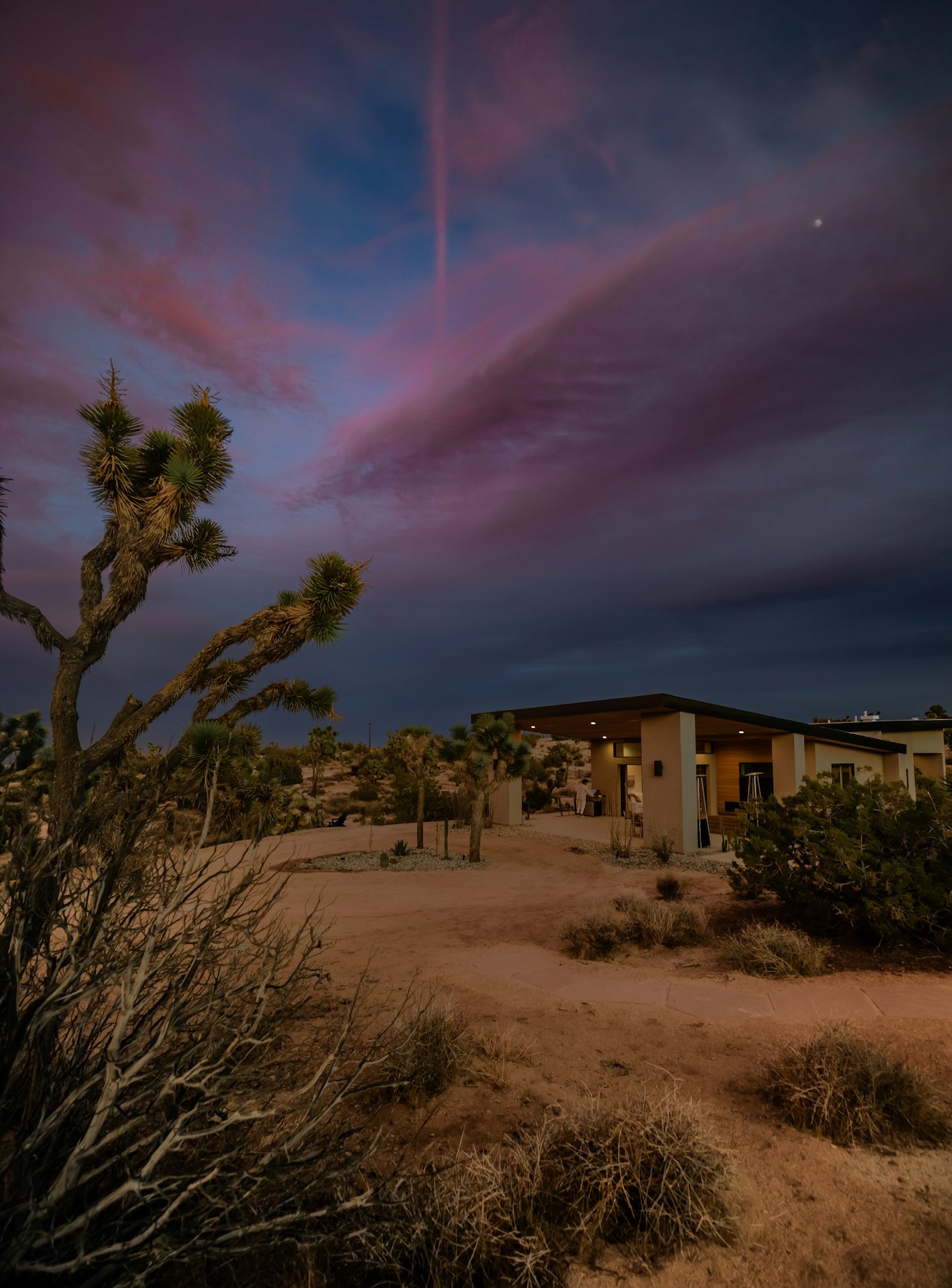 Arizona desert home glowing warmly at dusk