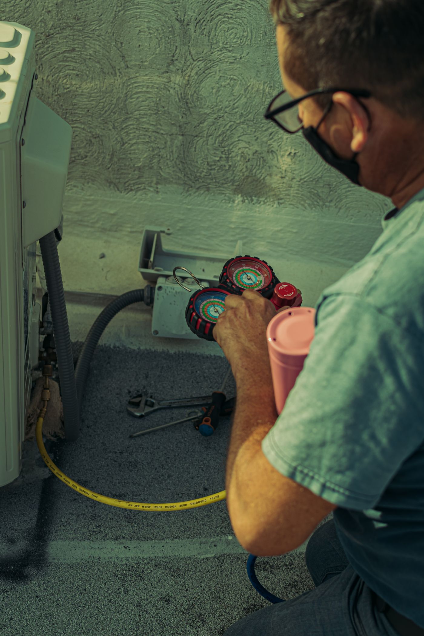 Copper State Air technician checking refrigerant pressures with manifold gauges