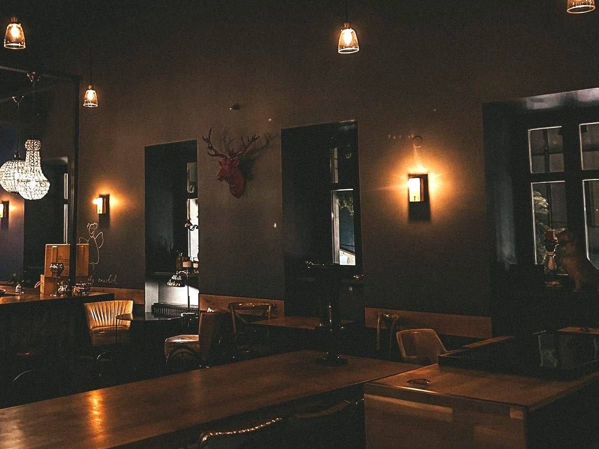 The Main Room — the full dining room under chandeliers