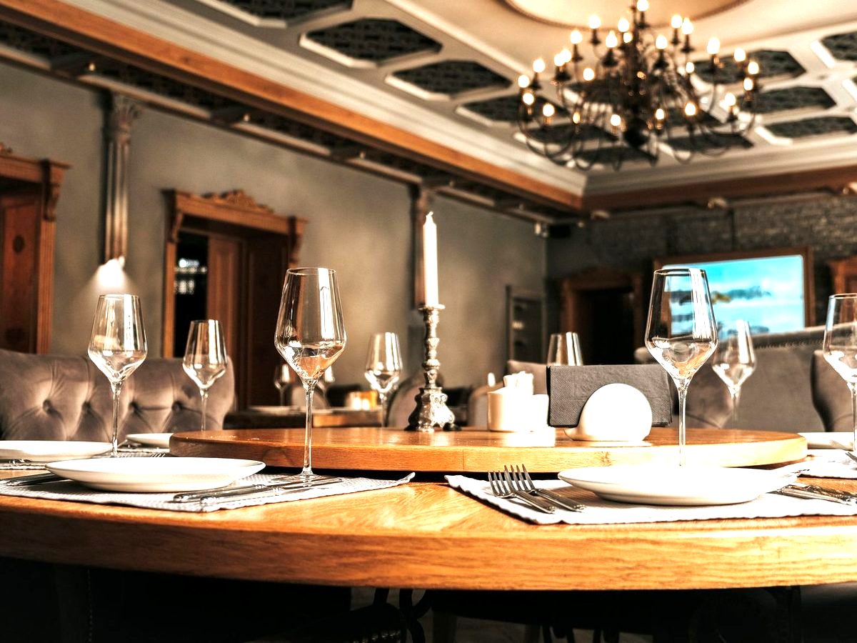 The Mezzanine — a round table set beneath a chandelier